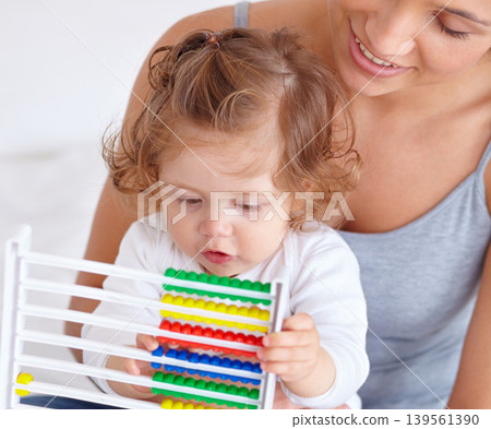 Abacus, math and toddler with mother playing, learning and teaching for child development on bed. Bonding, toy and closeup of mom teaching kid, infant or baby with counting in bedroom at home. Abacus, math and toddler with mother playing, learning and teaching for child development on bed. Bonding, toy and closeup of mom teaching kid, infant or baby with counting in bedroom at home. 139561390