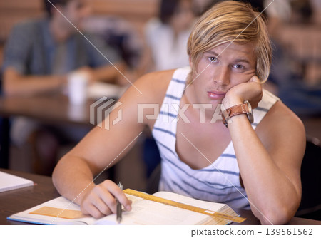 University, bored and portrait of man in classroom with books for studying, learning and research. Education, college and face of student tired, sad and upset with textbooks for assignment or test University, bored and portrait of man in classroom with books for studying, learning and research. Education, college and face of student tired, sad and upset with textbooks for assignment or test 139561562