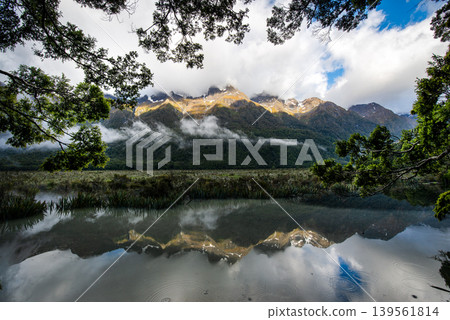 Reflection of Earl Mountains in Mirror Lakes along Milford Sound road, South Island, New Zealand. Reflection of Earl Mountains in Mirror Lakes along Milford Sound road, South Island, New Zealand. 139561814
