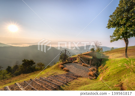 Scenic Sunrise Over Mountain Landscape with Rustic Cabin in Chiangrai 139561817