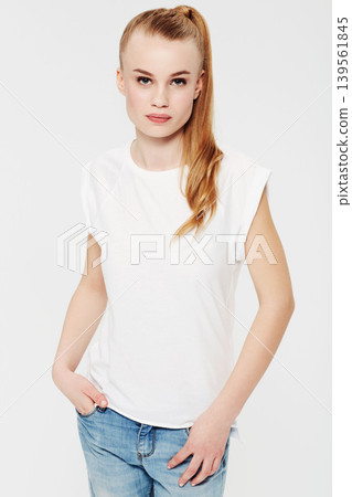 Serious, portrait and teenager with fashion in studio and white background with confidence and pride. Beauty, face and girl with a ponytail in casual trendy style, jeans and relax in mock up space Serious, portrait and teenager with fashion in studio and white background with confidence and pride. Beauty, face and girl with a ponytail in casual trendy style, jeans and relax in mock up space 139561845