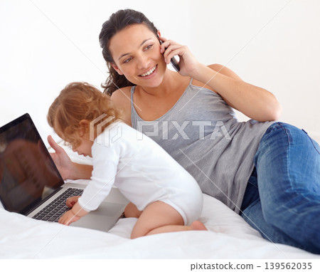 Working, phone call and mom with baby on laptop multitasking in home. Infant, kid and mother busy with computer and smartphone for remote work, productivity and online communication in bedroom Working, phone call and mom with baby on laptop multitasking in home. Infant, kid and mother busy with computer and smartphone for remote work, productivity and online communication in bedroom 139562035