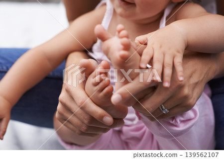Baby, feet and mom hands with love, bonding and child care with parenting and youth outdoor. Family, support and young kid with newborn, holding and barefoot with trust, toddler and relax with mother Baby, feet and mom hands with love, bonding and child care with parenting and youth outdoor. Family, support and young kid with newborn, holding and barefoot with trust, toddler and relax with mother 139562107