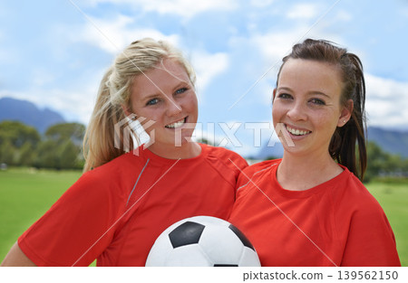 Happy woman, portrait and friends with soccer ball on green grass for sports, game or outdoor match. Female person or football players smile for fitness, training or practice on open field in nature Happy woman, portrait and friends with soccer ball on green grass for sports, game or outdoor match. Female person or football players smile for fitness, training or practice on open field in nature 139562150