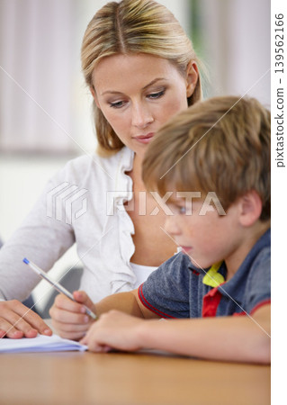 Teacher, student and help with school work in classroom, question and think of answer for education and knowledge. Teaching, learning and woman with boy in class, study and problem solving for test Teacher, student and help with school work in classroom, question and think of answer for education and knowledge. Teaching, learning and woman with boy in class, study and problem solving for test 139562166