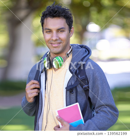 Portrait, man and happy student at park, university or outdoor campus in summer. Face, scholarship and smile of young person at college for education, learning and study with book in garden in Brazil 139562199