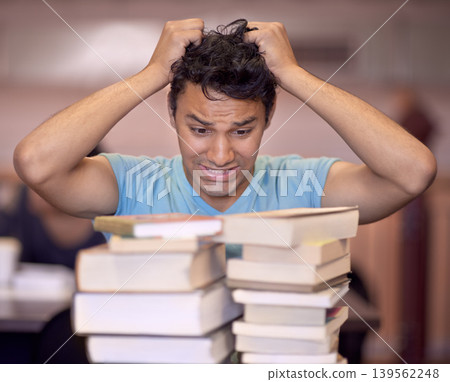 Student man, stress and stack of books for education, development and pulling hair at college library. Person, learning and knowledge with anxiety, fear and mental health for assessment at university 139562248