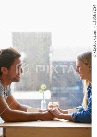 Space, cafe or happy couple holding hands on date talking or speaking of anniversary or holiday vacation. Tea drink, woman or romantic man in conversation for care, love or support in coffee shop Space, cafe or happy couple holding hands on date talking or speaking of anniversary or holiday vacation. Tea drink, woman or romantic man in conversation for care, love or support in coffee shop 139562254