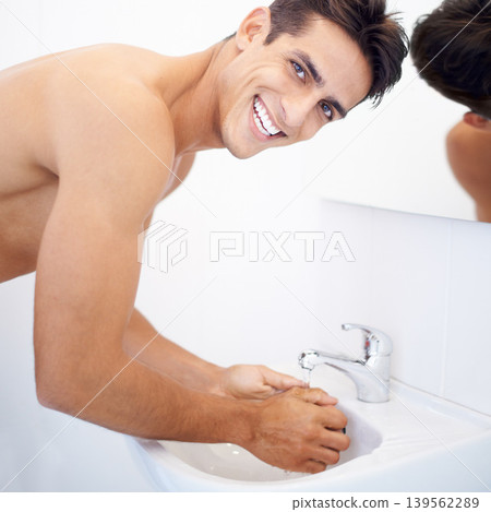 Man, washing hands and portrait for hygiene in mirror, clean and protection from germs. Male person, bathroom and wellness in morning routine, reflection and grooming or self care and basin at home Man, washing hands and portrait for hygiene in mirror, clean and protection from germs. Male person, bathroom and wellness in morning routine, reflection and grooming or self care and basin at home 139562289