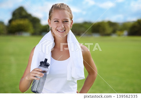 Happy woman, portrait and water bottle in fitness on green grass for workout, exercise or outdoor training. Face of female person or athlete with towel, drink or liquid for natural sustainability Happy woman, portrait and water bottle in fitness on green grass for workout, exercise or outdoor training. Face of female person or athlete with towel, drink or liquid for natural sustainability 139562335