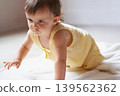 Baby, crawling and playing on floor, child development and infant growth with happy coordination and home. Girl, learning and healthy in good mood, childhood or balance with arms, kid or adorable 139562362