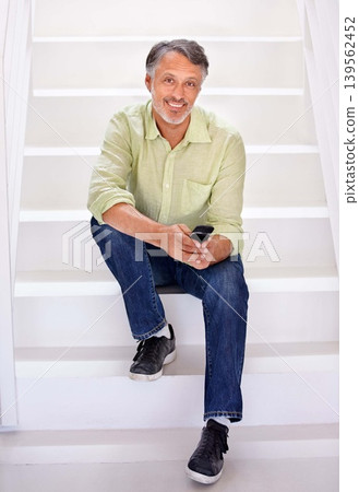 Man, portrait or phone on stairs in office for social network, download digital app or business contact in agency. Happy mature entrepreneur typing on smartphone, mobile notification or chat on steps 139562452