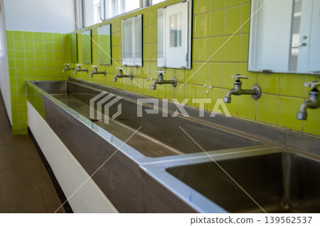 A traditional elementary school bathroom A traditional elementary school bathroom 139562537