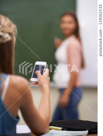 Smartphone, student and texting in classroom, social media and communication in school. Female person, behind and internet connection or back, website and mobile application for games and education Smartphone, student and texting in classroom, social media and communication in school. Female person, behind and internet connection or back, website and mobile application for games and education 139562538