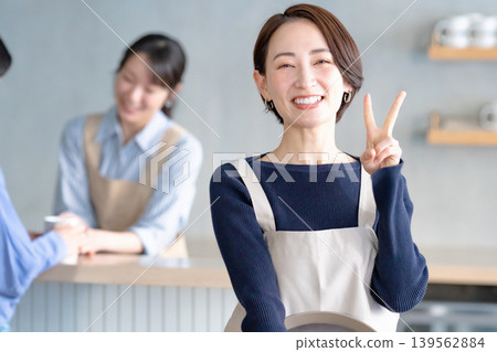 A woman working in a cafe A woman working in a cafe 139562884