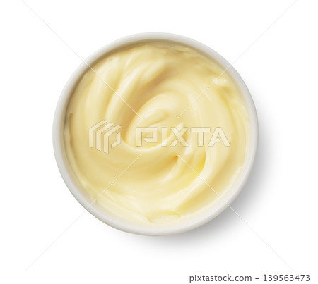 A top-down view of mayonnaise in a white ramekin against a white background, with a swirling texture. A top-down view of mayonnaise in a white ramekin against a white background, with a swirling texture. 139563473