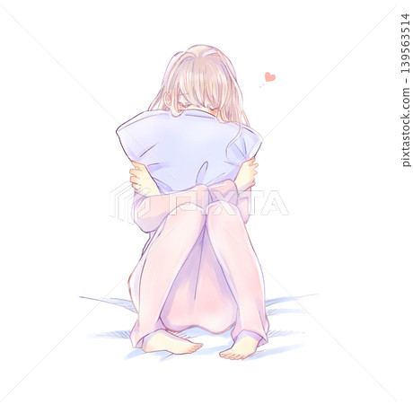 A woman hugging a cushion; love; on a bed. A woman hugging a cushion; love; on a bed. 139563514