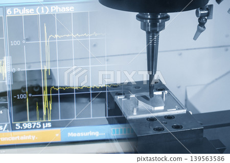 Abstract industrial technology concept featuring a CNC milling machine integrated with a data graph monitor in a blue-toned scene. Abstract industrial technology concept featuring a CNC milling machine integrated with a data graph monitor in a blue-toned scene. 139563586