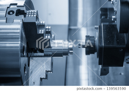 High-precision hole guide drilling using a center drill tool on a metal shaft part with a CNC lathe machine. 139563590