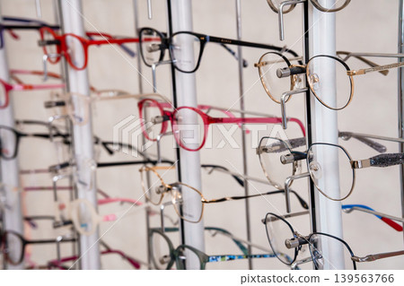 Colorful Eyeglasses Collection Displayed on Retail Stand in Optical Shop with Variety of Frames for Vision Correction Colorful Eyeglasses Collection Displayed on Retail Stand in Optical Shop with Variety of Frames for Vision Correction 139563766