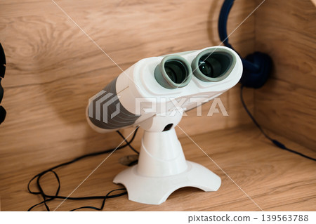 White Baby Binoculars With Grey Stripes On Wooden Shelf Close Up Product Shot For Toddlers And Kids Optical Toy Viewfinder White Baby Binoculars With Grey Stripes On Wooden Shelf Close Up Product Shot For Toddlers And Kids Optical Toy Viewfinder 139563788