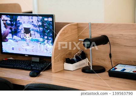 Desktop Monitor with Game Character Displayed on Screen at Wood Desk Desktop Monitor with Game Character Displayed on Screen at Wood Desk 139563790