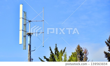 Vertical axis wind turbine against a sky. Renewable energy and the advancement of sustainable technology in the fight against climate change. 139563834