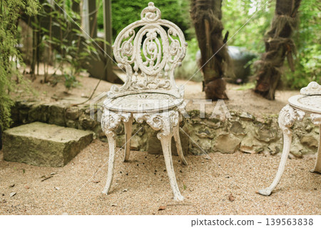White patterned vintage antique wrought iron chair 139563838