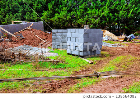 Construction site with building materials cinder blocks gravel path 139564092