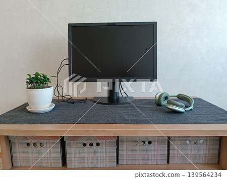 Minimalist Desk Setup with Monitor and Headphones 139564234