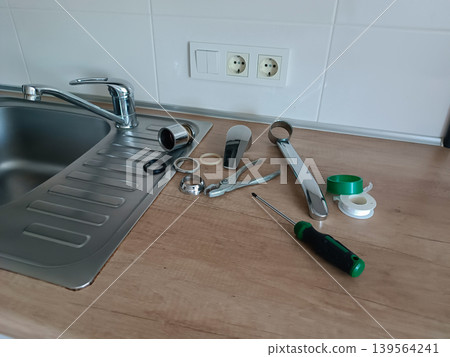 DIY Faucet Repair Tools on Kitchen Sink DIY Faucet Repair Tools on Kitchen Sink 139564241