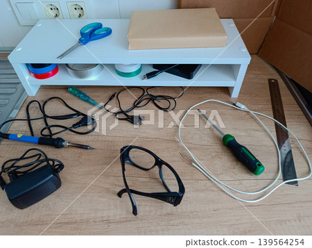 Electronics repair workbench with tools and components Electronics repair workbench with tools and components 139564254