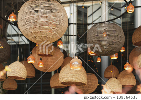 Artistic hanging lanterns creating cozy ambiance inside contemporary architectural space Artistic hanging lanterns creating cozy ambiance inside contemporary architectural space 139564535