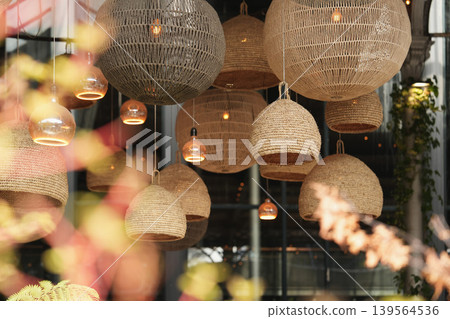 Warm decorative lanterns suspended beautifully within luxurious hospitality interior today 139564536