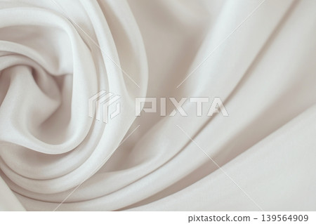 Beige silk fabric texture background. Close-up of elegant light beige silk fabric with soft folds and draperies. Beige silk fabric texture background. Close-up of elegant light beige silk fabric with soft folds and draperies. 139564909