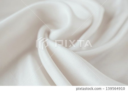 Beige silk fabric texture background. Close-up of elegant light beige silk fabric with soft folds and draperies. Beige silk fabric texture background. Close-up of elegant light beige silk fabric with soft folds and draperies. 139564910