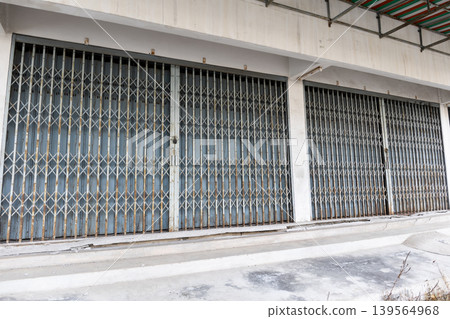 Old Commercial Building with Classic Folding Metal Shutter Gates Old Commercial Building with Classic Folding Metal Shutter Gates 139564968