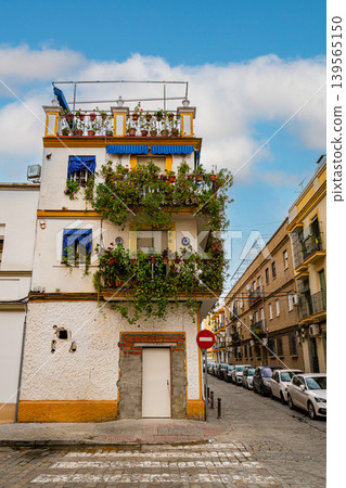 Traditional Seville House With Flowered Balconies On Narrow Street Traditional Seville House With Flowered Balconies On Narrow Street 139565150