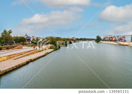 Guadalquivir River View In Seville With Riverside Promenade Guadalquivir River View In Seville With Riverside Promenade 139565151