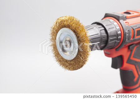 drilling machine with metal brush isolated on white background drilling machine with metal brush isolated on white background 139565450