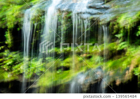 Blurred Waterfall with Lush Green Foliage Blurred Waterfall with Lush Green Foliage 139565484