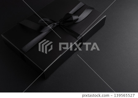 Black Gift Box with Satin Ribbon.on Black Background Black Gift Box with Satin Ribbon.on Black Background 139565527