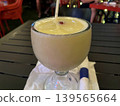 Glass of pina colada on a table. 139565664