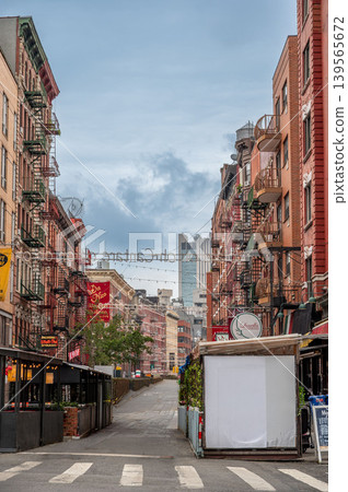 New york, usa august 17,2024. Mulberry street showing brick buildings with fire escapes and outdoor dining structures in little italy, manhattan, new york New york, usa august 17,2024. Mulberry street showing brick buildings with fire escapes and outdoor dining structures in little italy, manhattan, new york 139565672