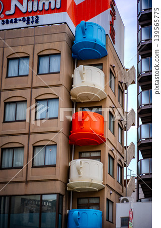 A building lined with giant mugs A building lined with giant mugs 139565775