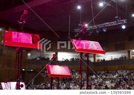 Music stands with sheet music on stage before a concert Music stands with sheet music on stage before a concert 139565899