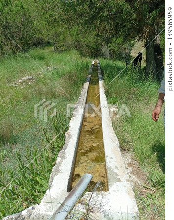 Traditional long stone water trough for livestock in the Spanish countryside Traditional long stone water trough for livestock in the Spanish countryside 139565959