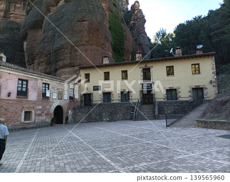 Sanctuary of Virgen de la Hoz built into red sandstone cliffs in Guadalajara, Spain. Sanctuary of Virgen de la Hoz built into red sandstone cliffs in Guadalajara, Spain. 139565960