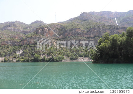 Majestic Limestone Cliffs over the Green Waters of Cortes de Pallas Lake 139565975