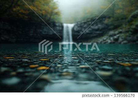 Hidden waterfall cascades into a tranquil blue pool Hidden waterfall cascades into a tranquil blue pool 139566170